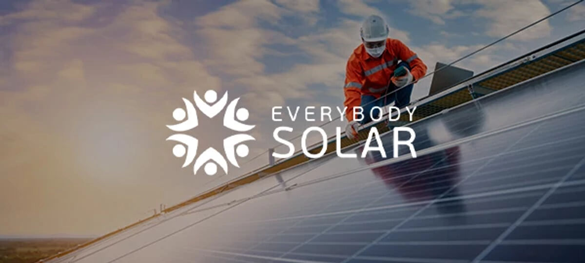Everybody Solar logo on a background image of a man on a solar panel Everybody Solar logo on a background image of a man on a solar panel