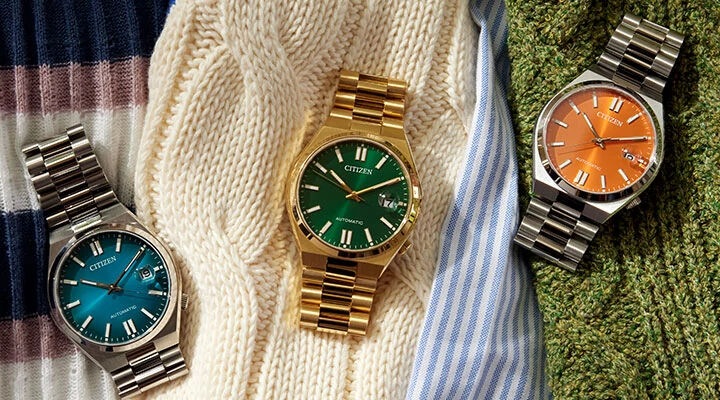 Image of three TSUYOSA models laying on top of sweaters. Image features watch models NJ0151-53X, NJ0152-51X and NJ0151-53Z